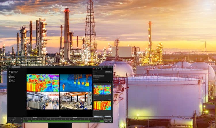 Industrial refinery at sunset with a monitor overlay showing thermal camera footage of the facility's equipment and pipelines