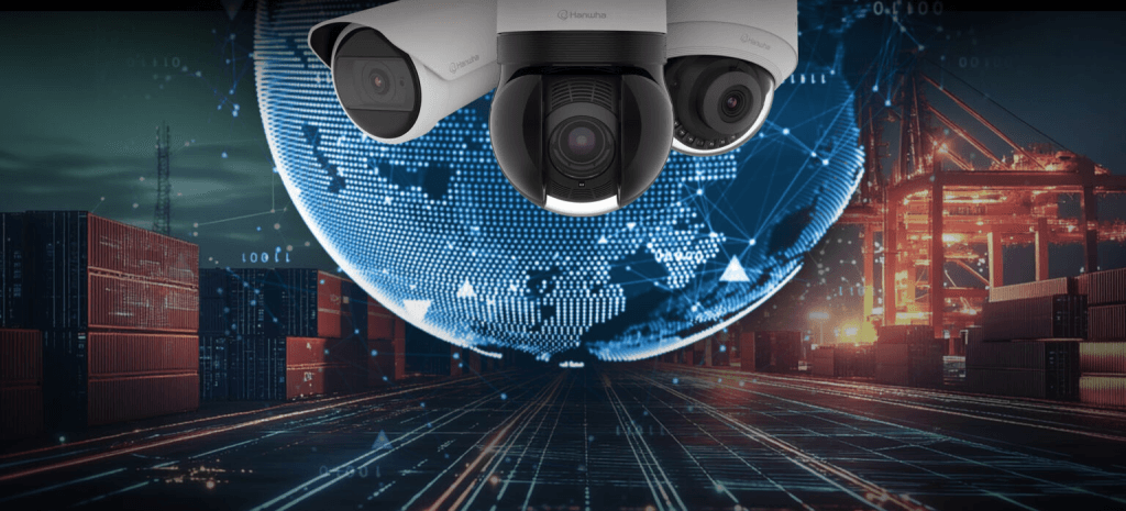 Three Hanwha Vision security cameras overlaid on a digital globe graphic, set against a nighttime shipping port with cargo containers and cranes